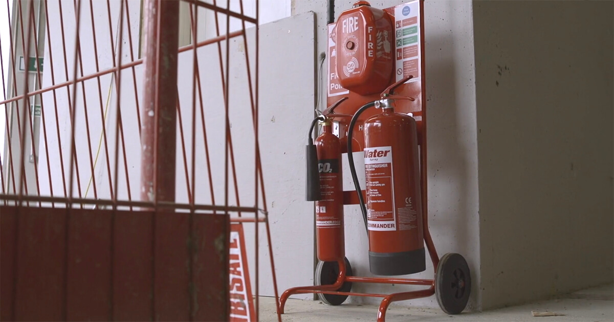 firepost against wall with call point and fire extinguishers