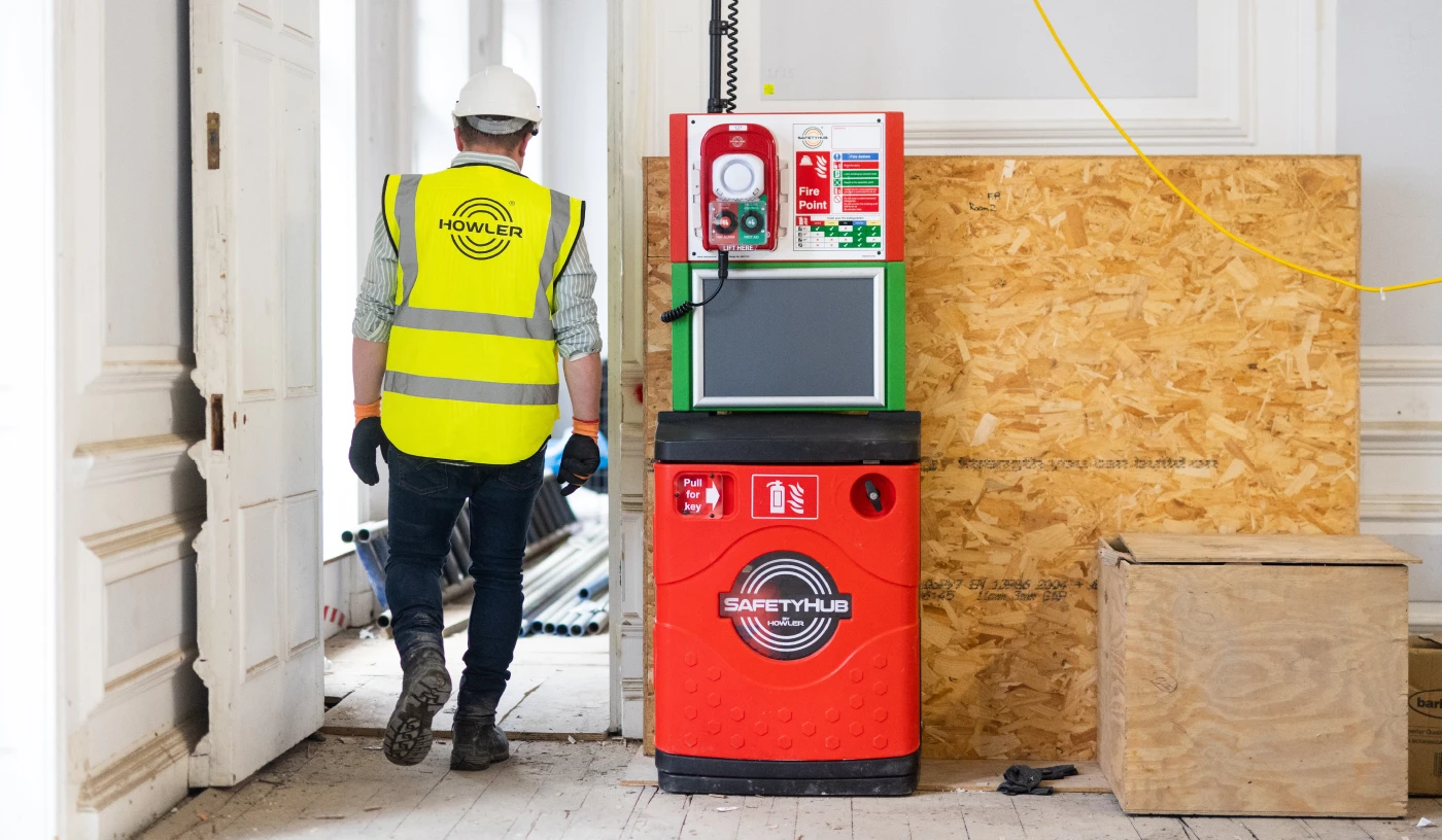 Howler Safety Hub on construction site with Howler employee walking through site